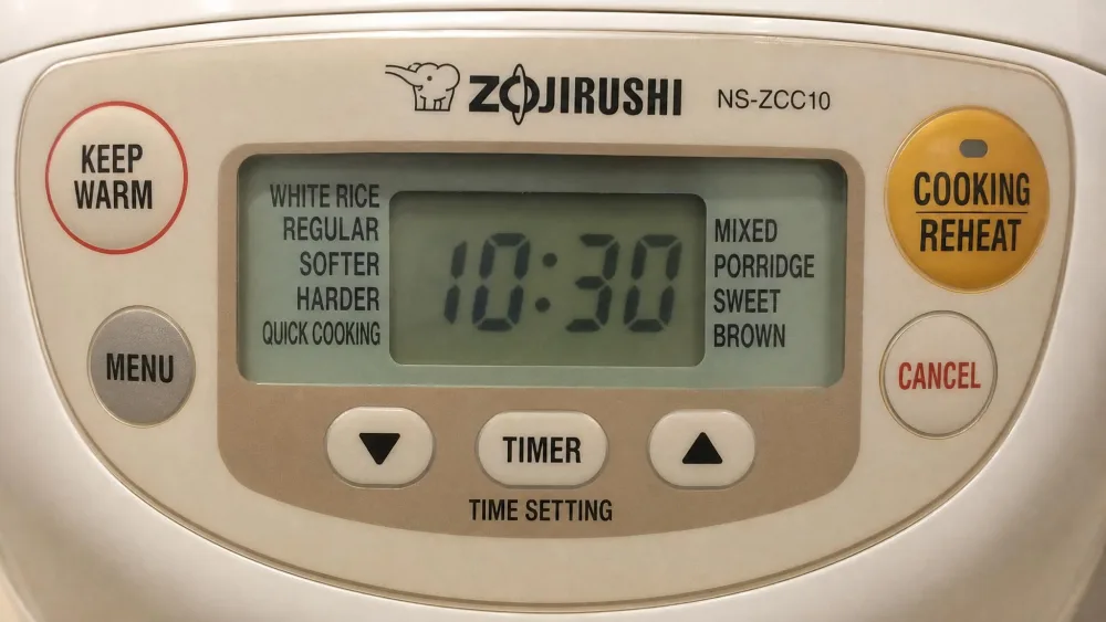 Close-up of the Zojirushi NS-ZCC10 beige LCD control panel and menu buttons.